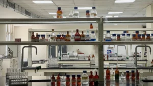 A photograph showing glass bottles on laboratory shelves.